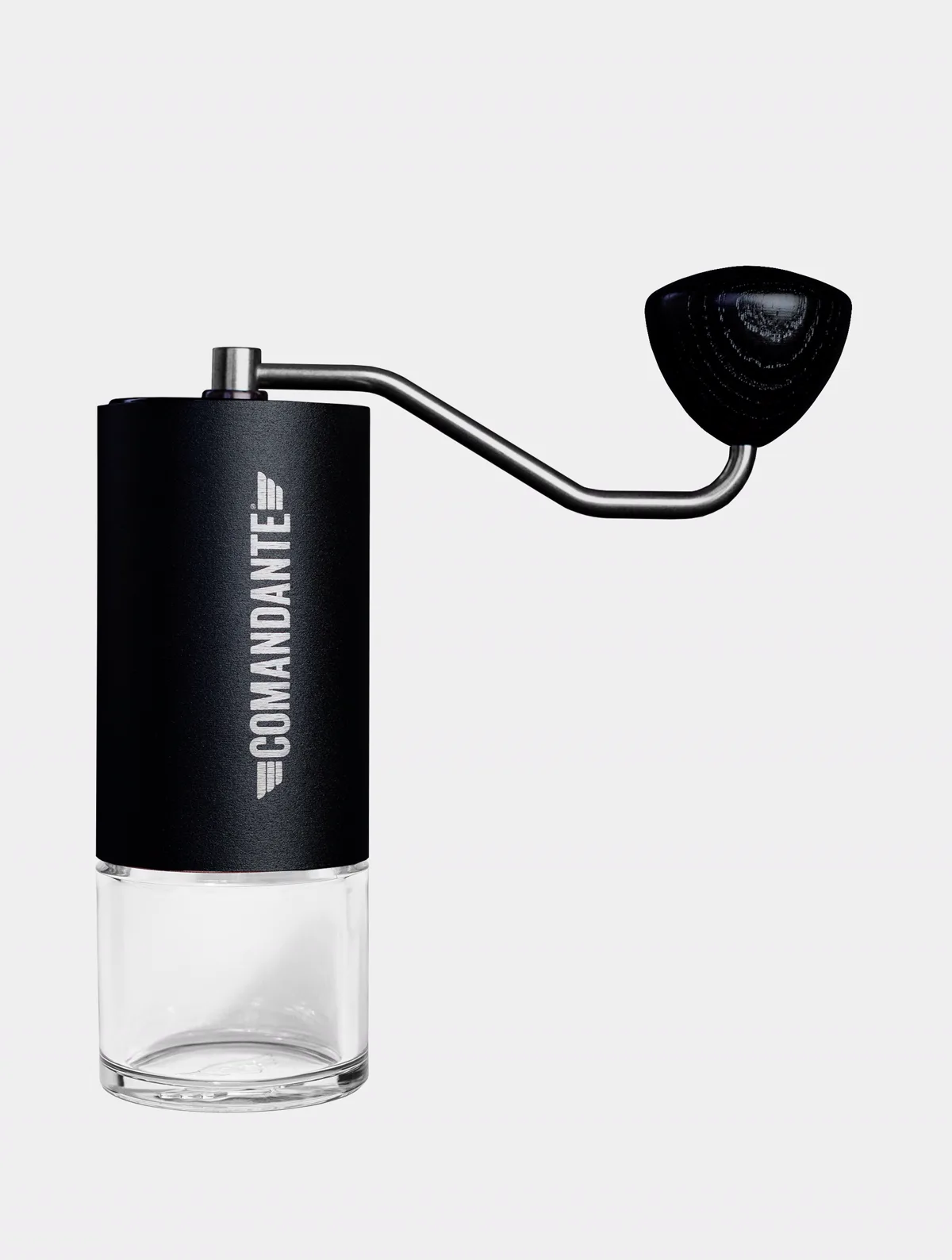 Black Comandante manual coffee grinder with steel crank handle and clear glass grounds container.