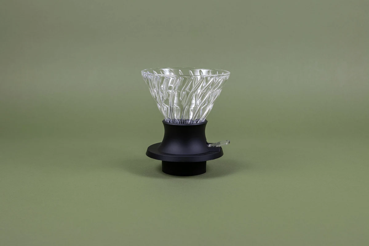 Hario V60 Switch glass immersion dripper, size 03, on a black base with its switch lever
