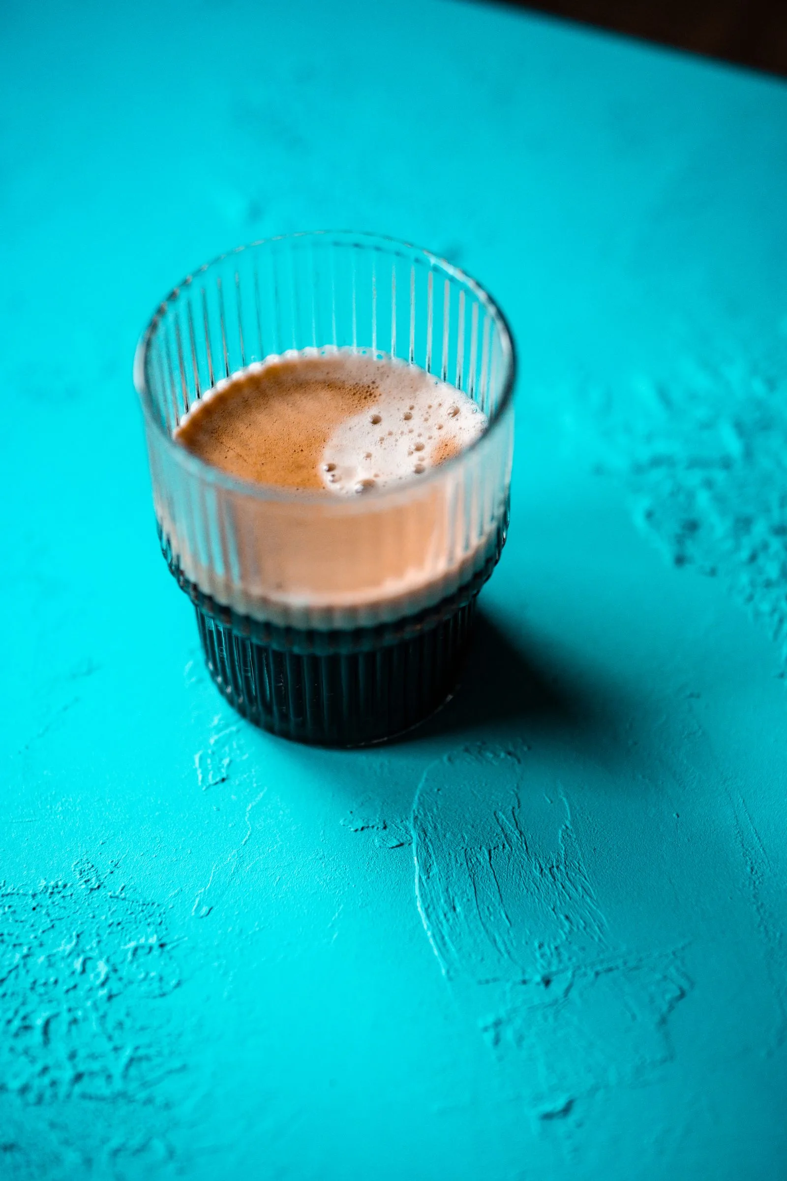 Rich golden-brown crema foam layer visible on the surface of a freshly extracted espresso shot