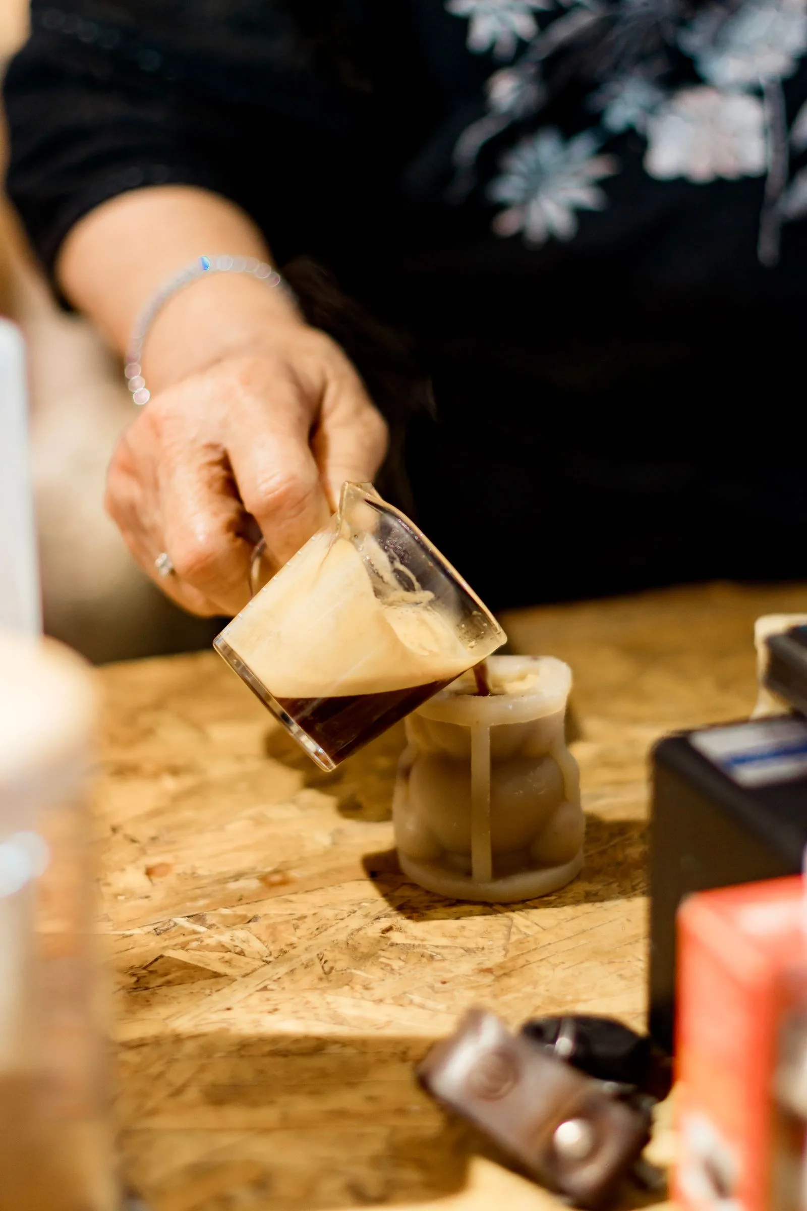 Barista actively preparing an espresso shot with coffee grounds and portafilter
