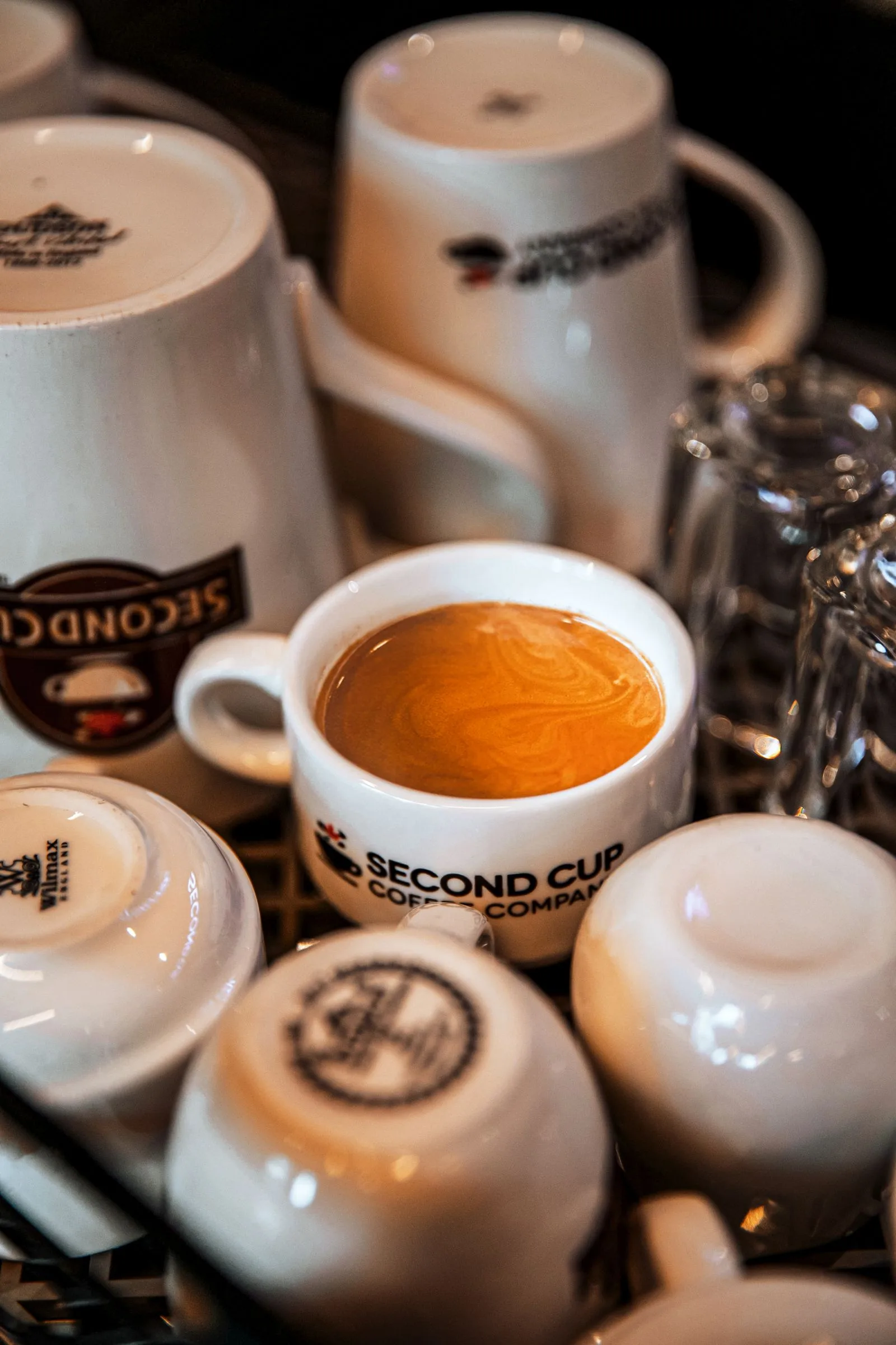 Espresso cup positioned next to a standard coffee mug showing different serving sizes