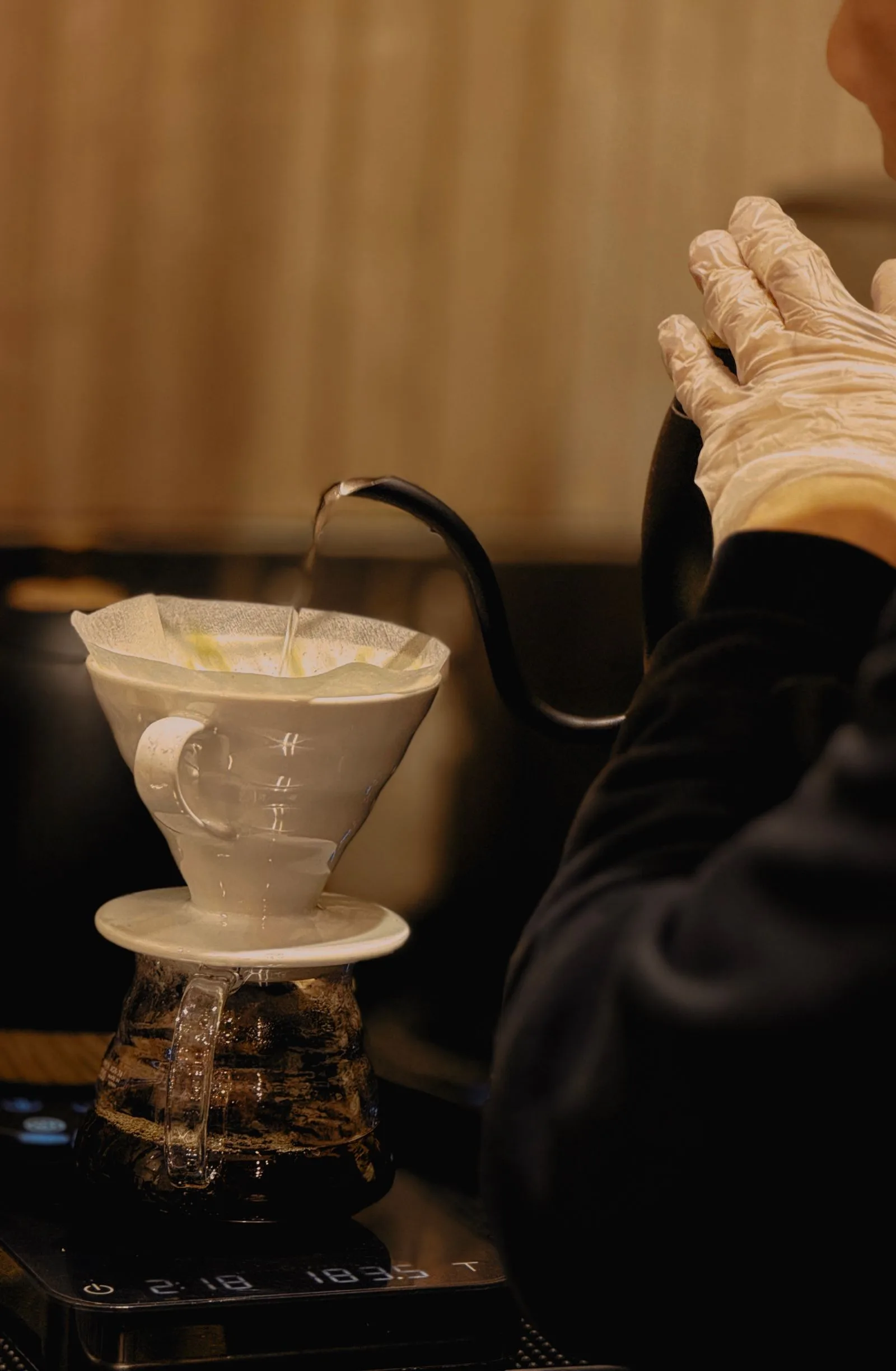V60 dripper cone with white paper filter on mug