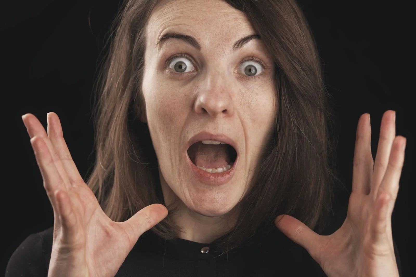 Person experiencing panic with hands to chest or face