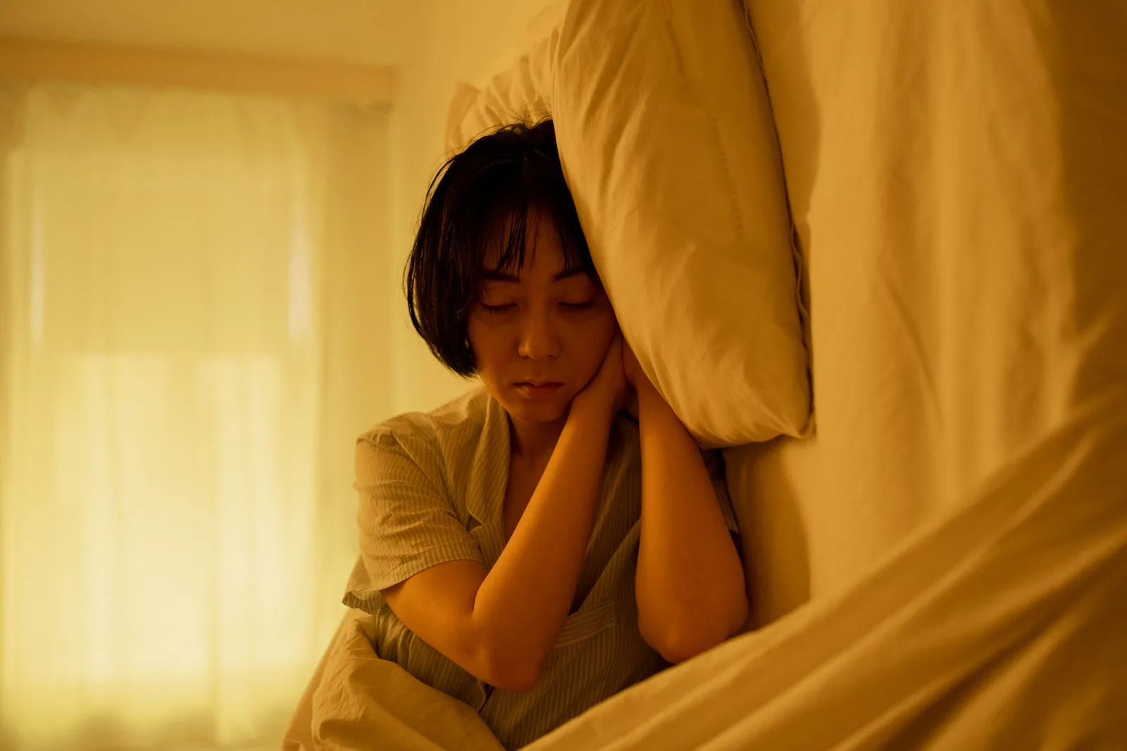Person in bed struggling with disrupted sleep quality