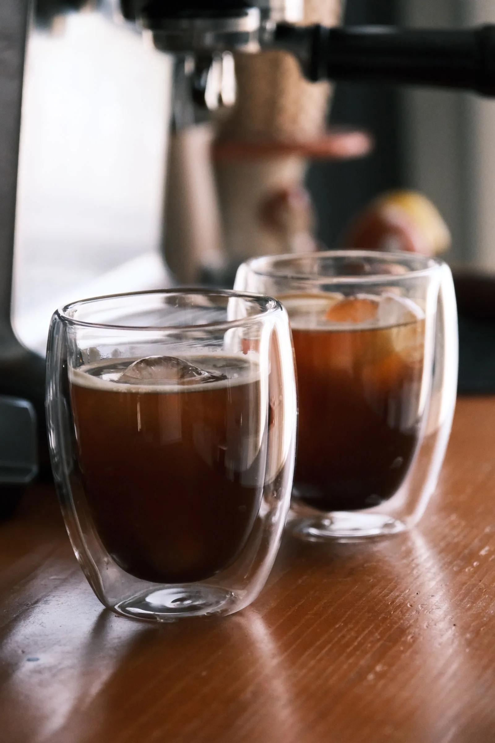 Cold brew coffee poured over ice in a clear glass