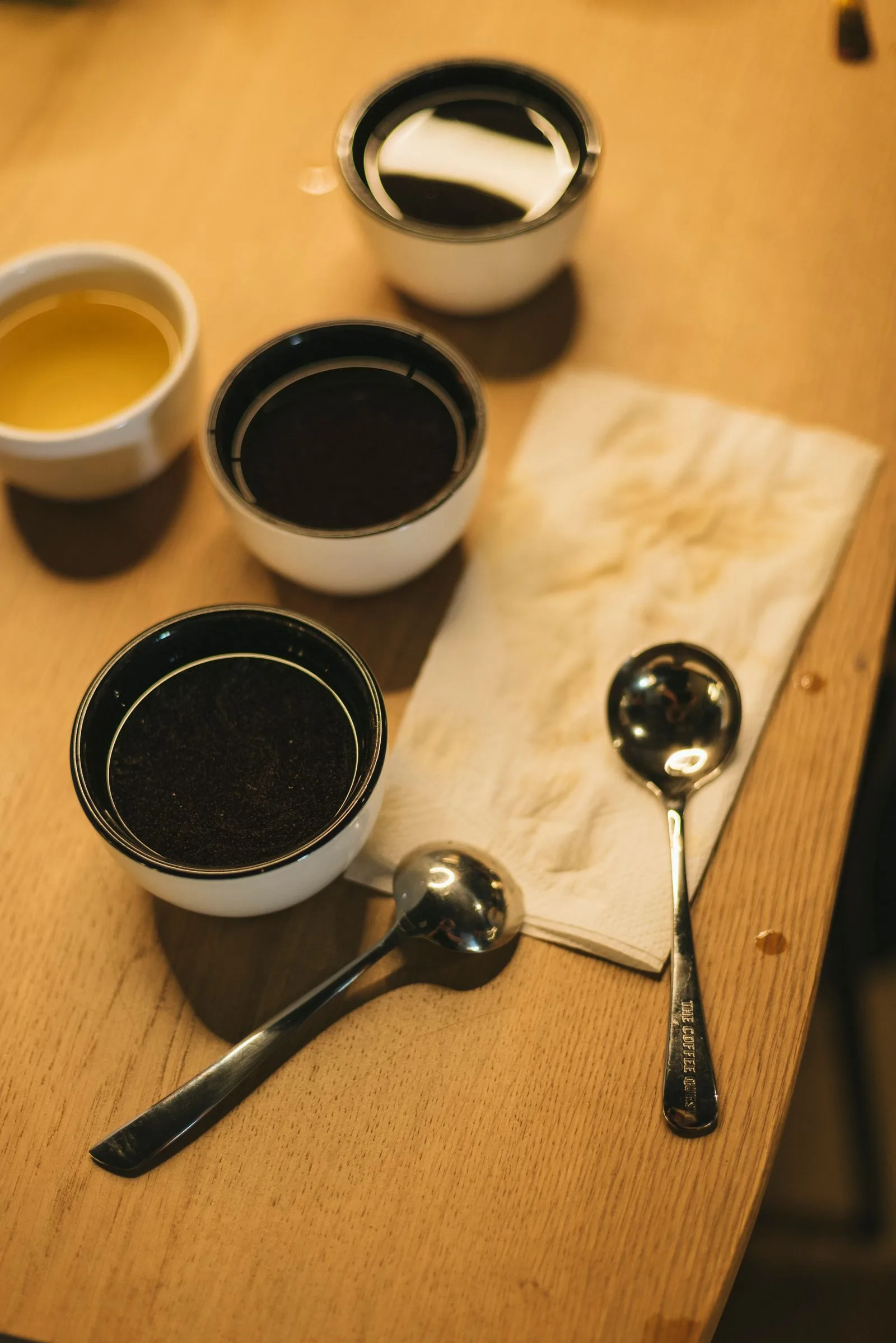 Multiple coffee cups lined up for taste testing and comparison