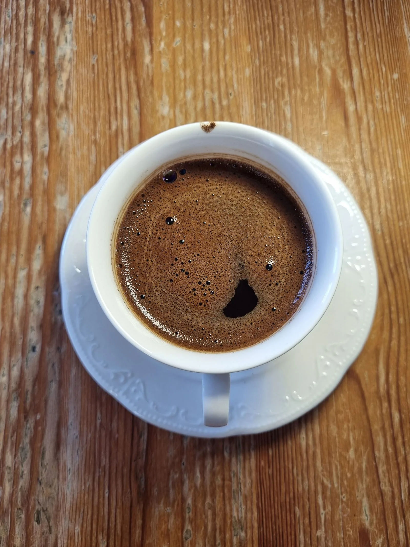 Dark, strong brewed coffee in a cup showing intensity