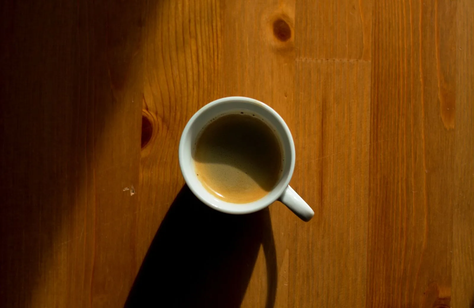 Dark concentrated espresso shot in small cup