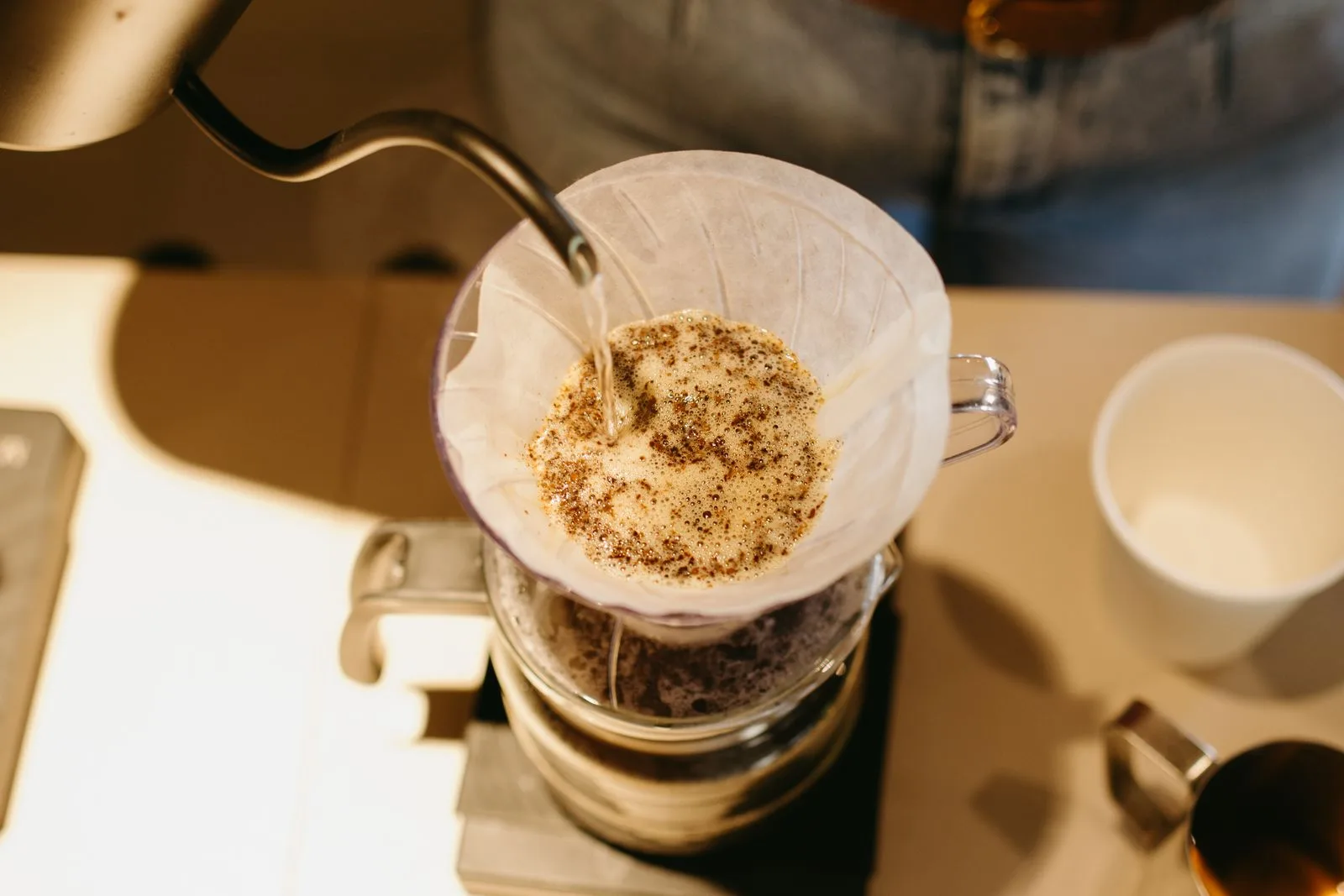 Hot water pouring through ground coffee during brewing