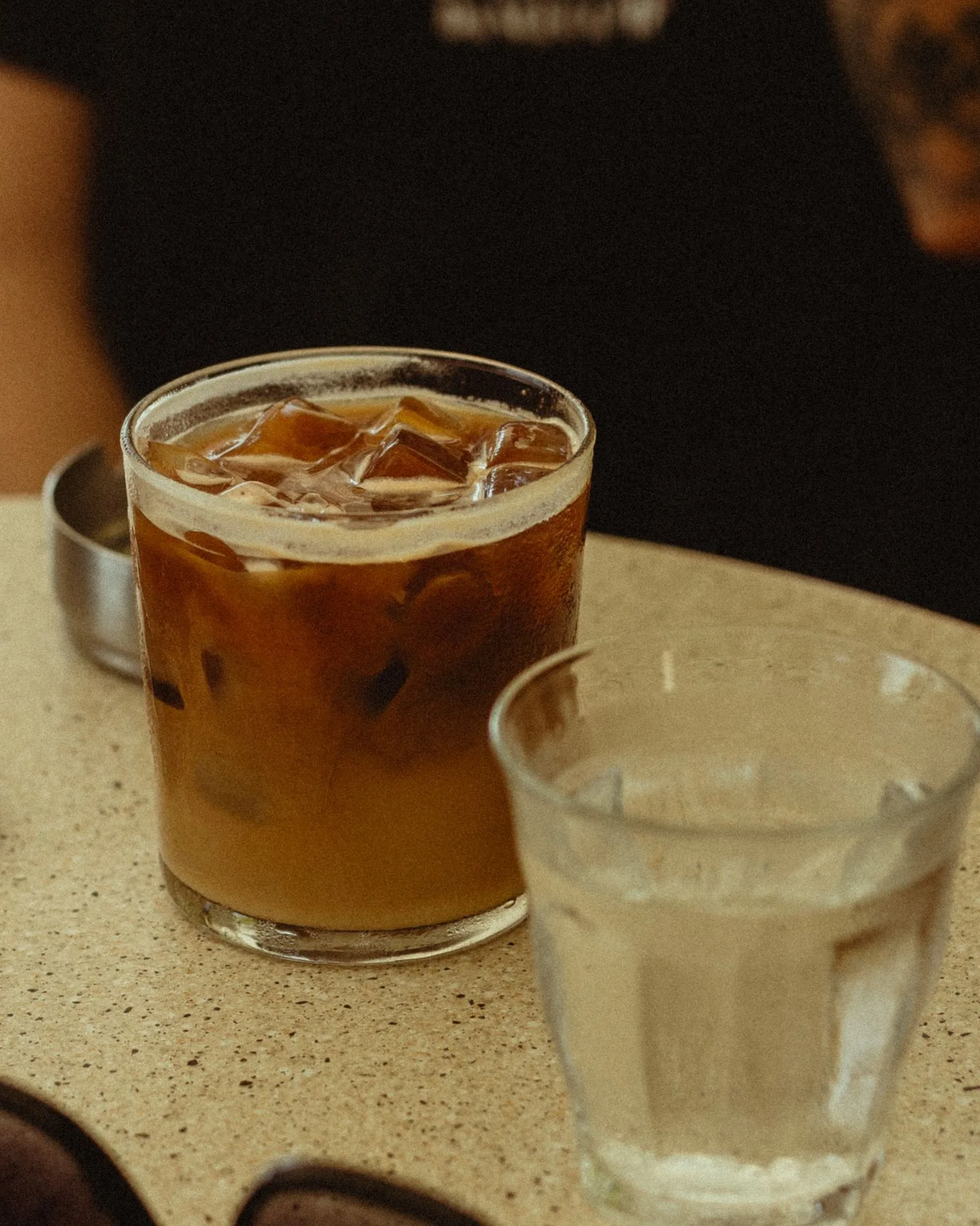 Iced coffee in tall glass with ice cubes
