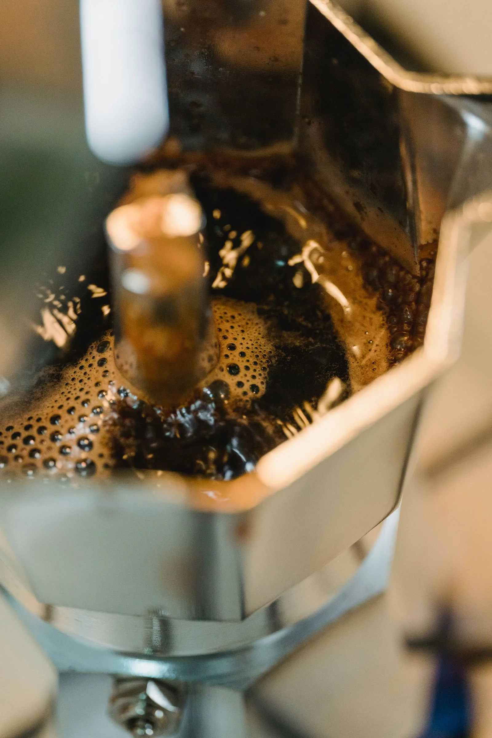 Water and steam rising through moka pot chambers during brewing