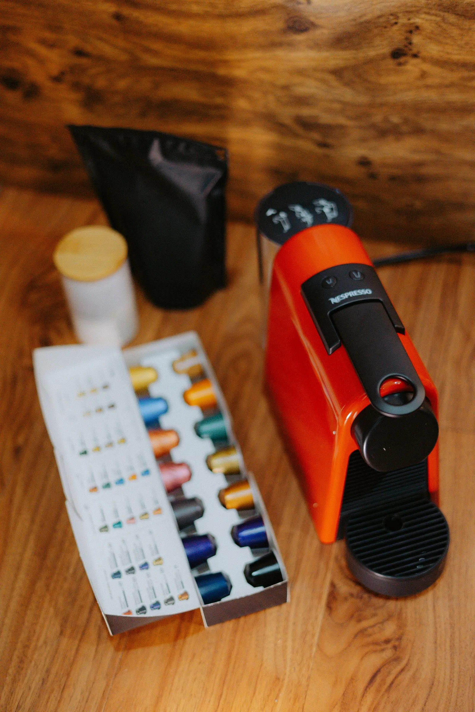 Compact Nespresso machine brewing espresso into small cup with capsule pod visible