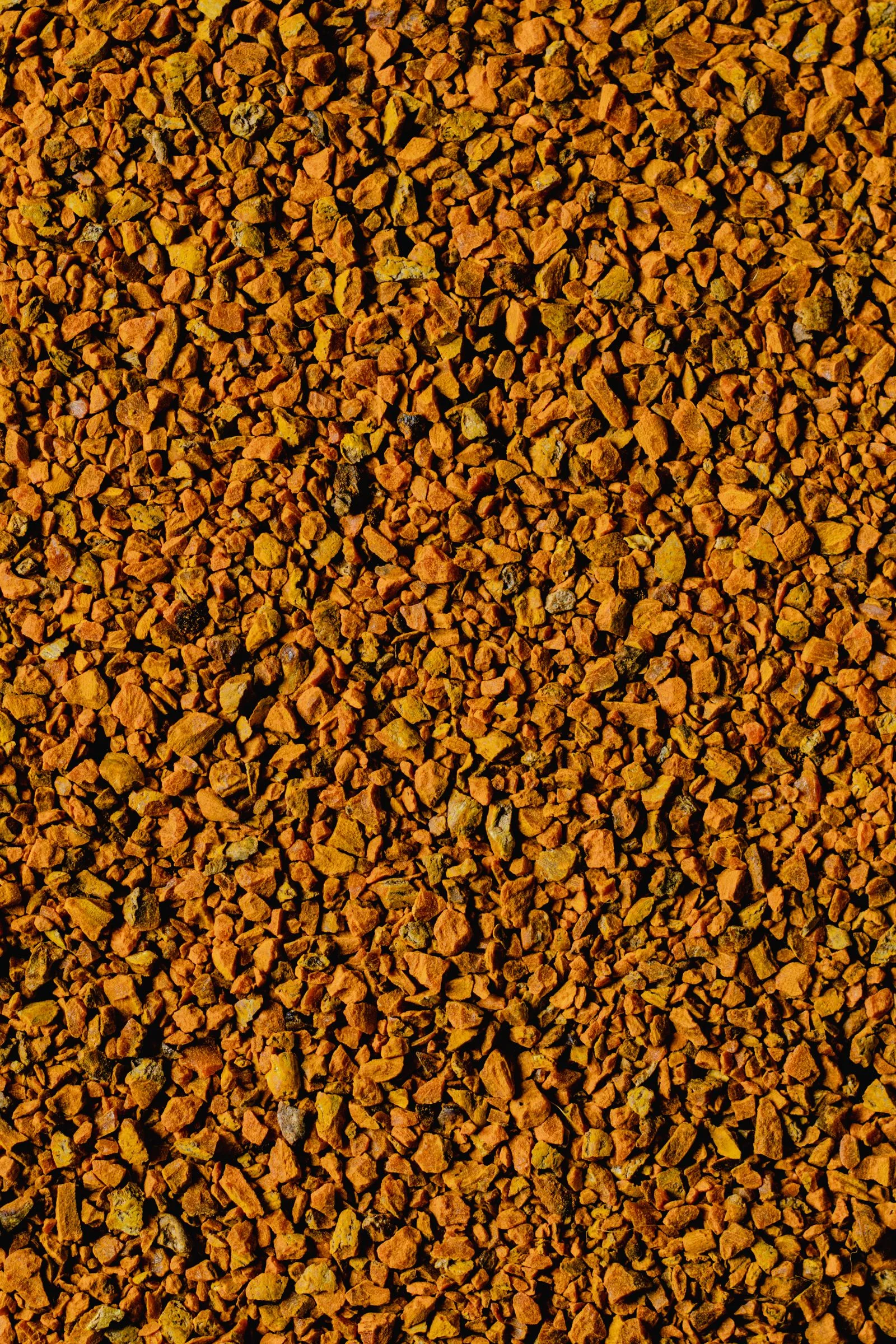 Magnified view of ground coffee showing fine dust particles
