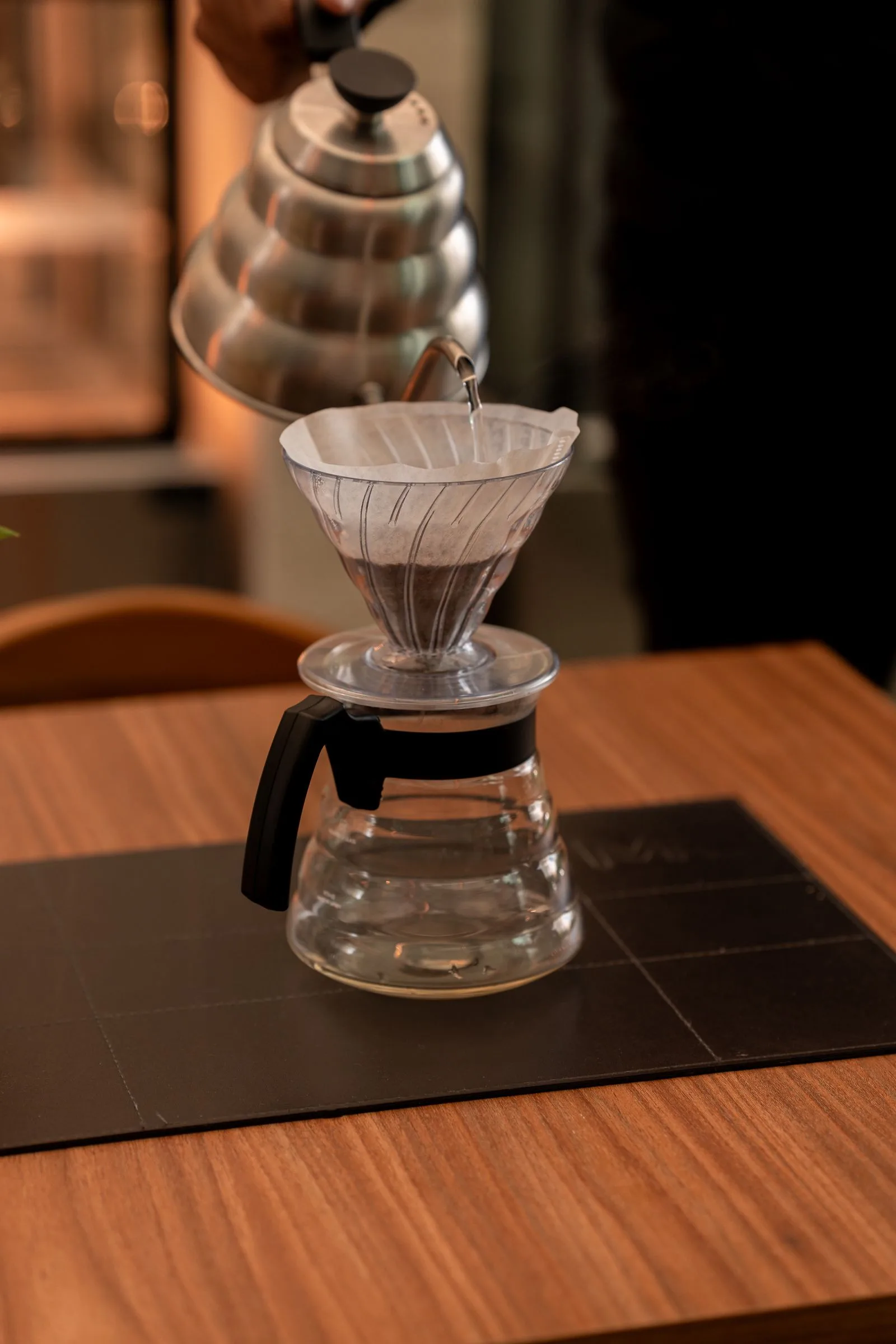 Temperature-controlled gooseneck kettle pouring hot water for brewing