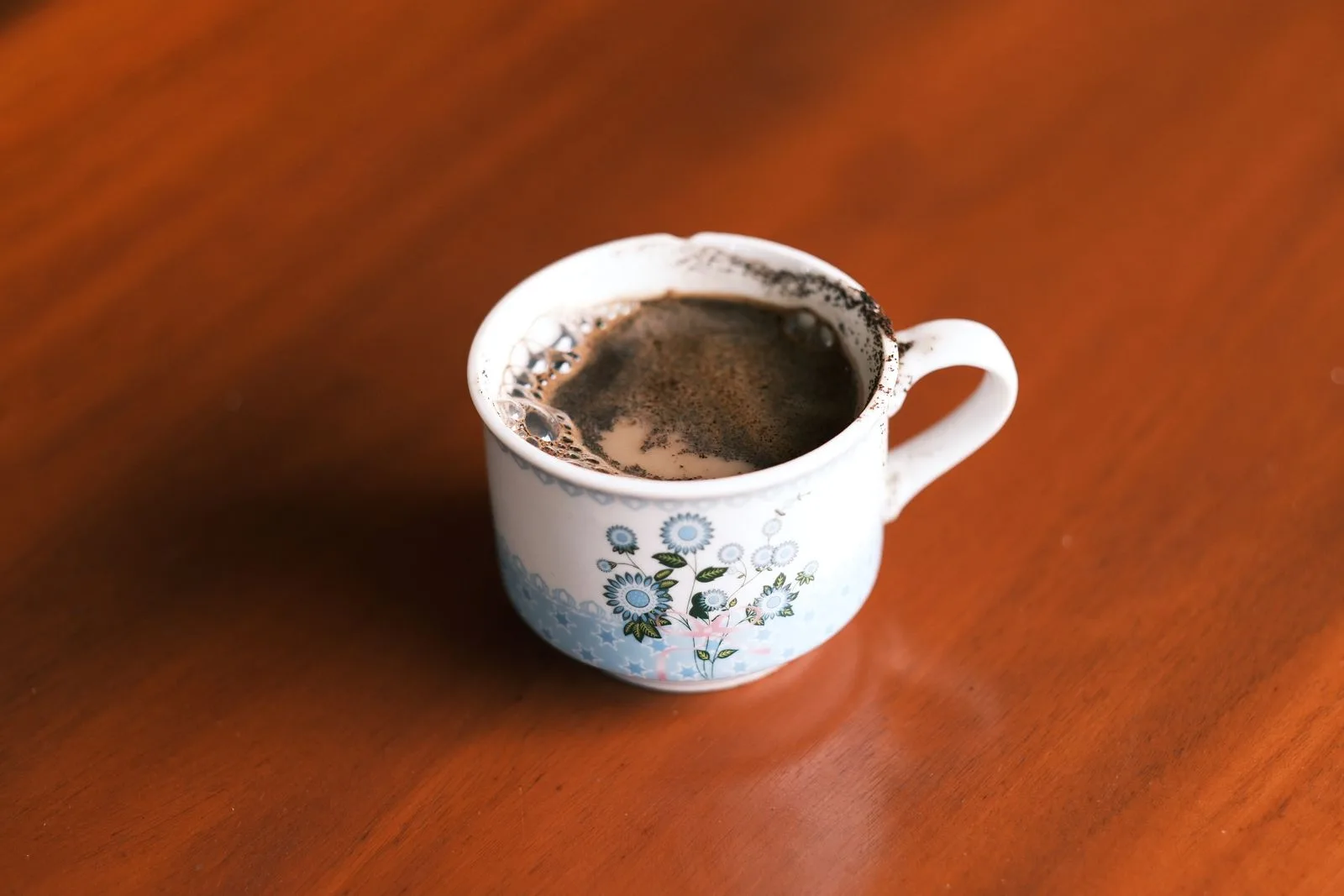 Pale, weak coffee in a white cup showing thin body and light color