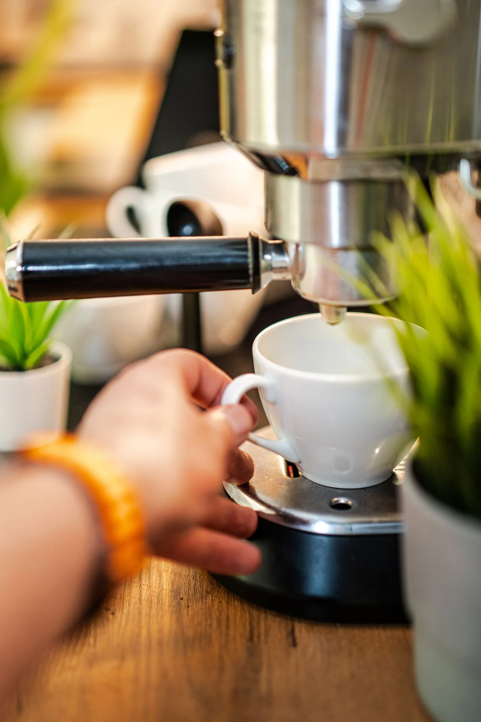 Coffee maker parts being rinsed and washed under running water